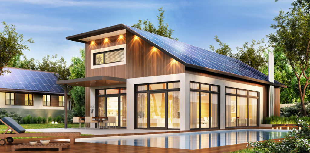 Large modern house with solar panels on the roof harnessing the suns energy